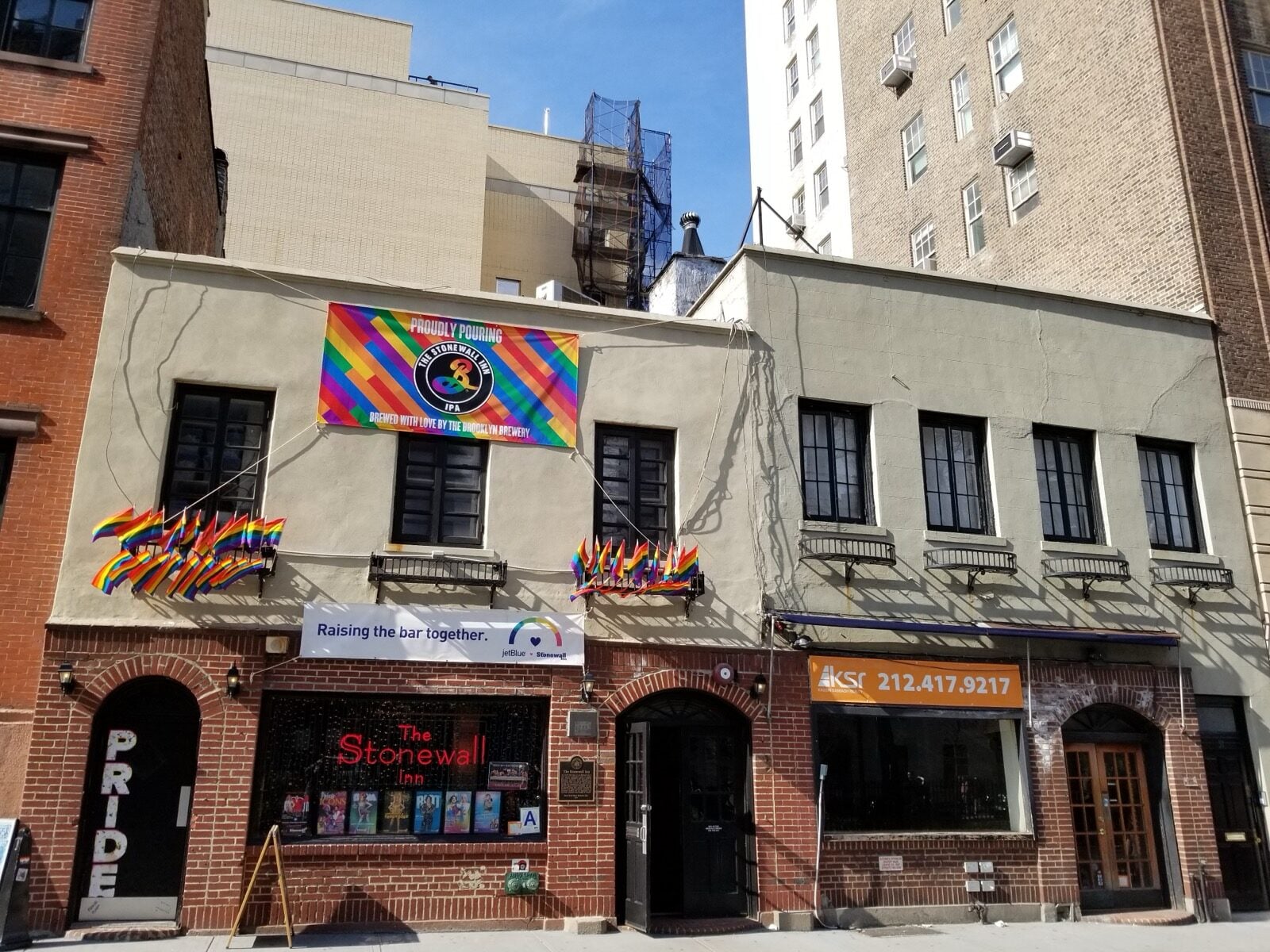 Exterior of the Stonewall Inn in New York with Pride flags, April 2019